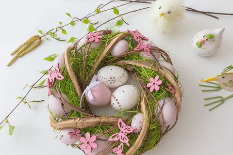 a plat wreath with easter eggs in the centre